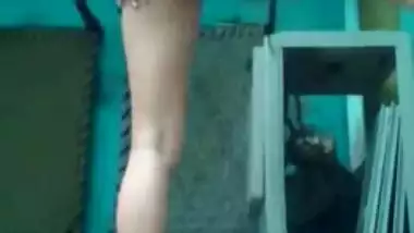 Indian babe stays in front of camera and shakes appetizing buttocks