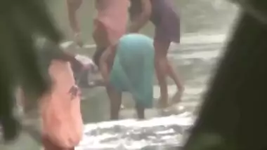 Tamil women bathing by the river