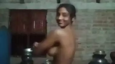 Village girl applying lotion to full nude body