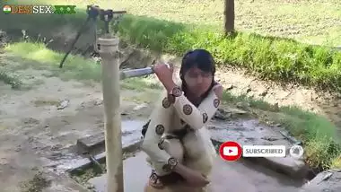 Young village school girl taking a bath in a sari and caught on camera
