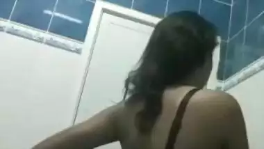 Off-color woman from India filmed on camera putting clothes on XXX body
